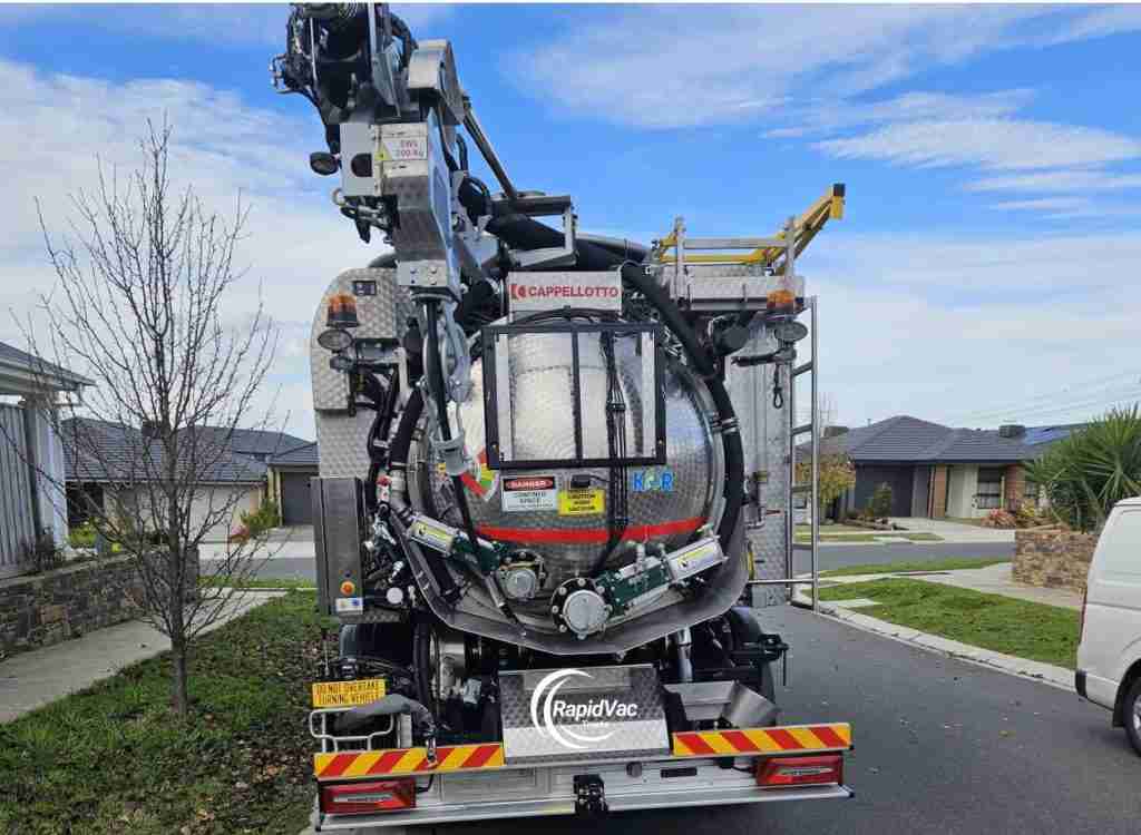 Hydro excavation equipment clearing soil around underground services.